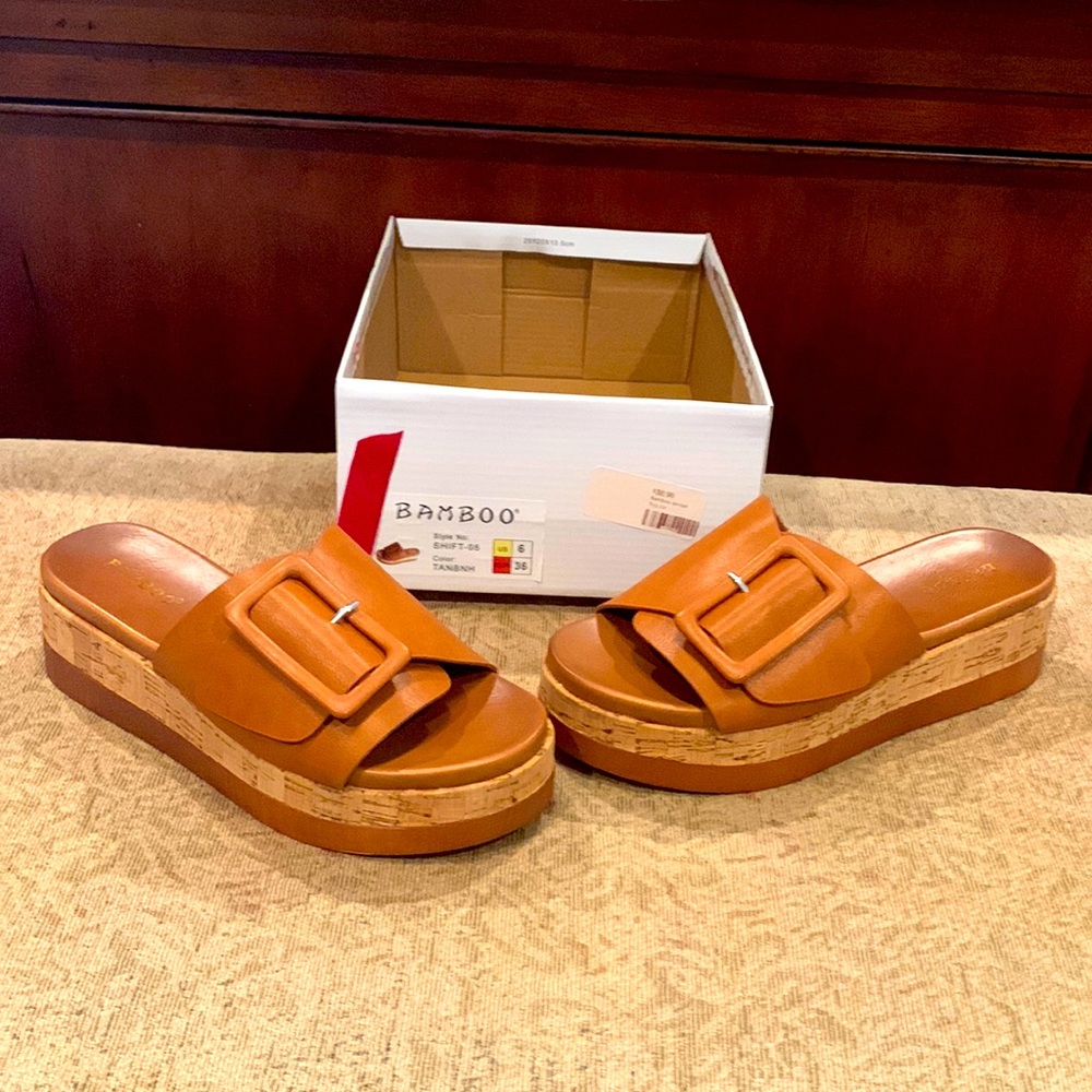Brand new , never worn , size 6 slip on sandals .